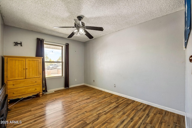 541 W Deuce Of Clubs, Show Low, AZ 85901 - unfurnished bedroom with a textured ceiling, wood finished floors, and baseboards