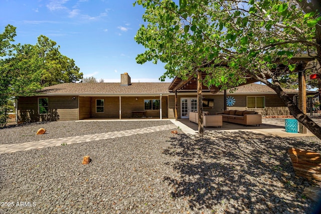541 W Deuce Of Clubs, Show Low, AZ 85901 - rear view of house featuring outdoor lounge area, a chimney, french doors, and a patio area