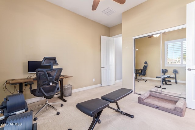 carpeted office featuring ceiling fan