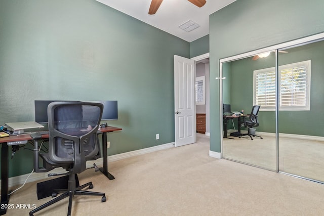 carpeted office featuring ceiling fan