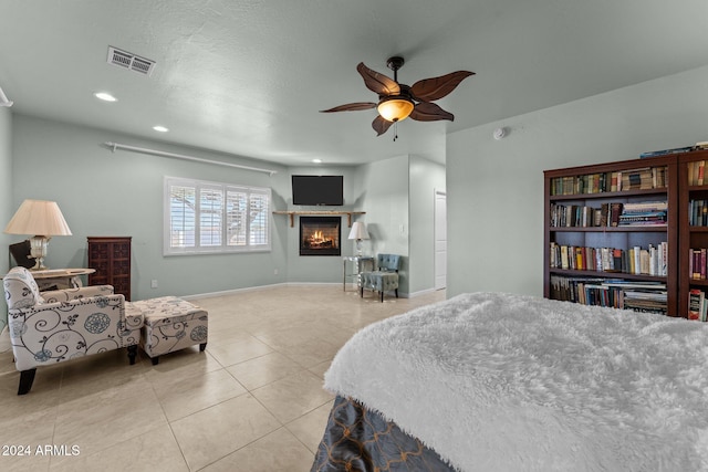 tiled bedroom featuring ceiling fan