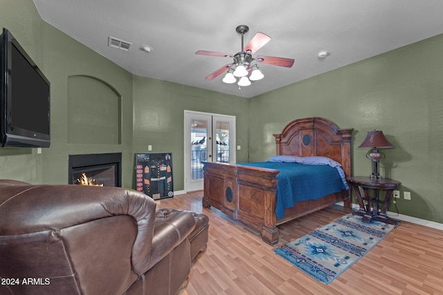 bedroom with french doors, ceiling fan, light hardwood / wood-style flooring, and access to exterior