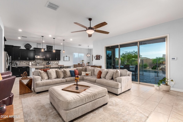 tiled living room featuring ceiling fan