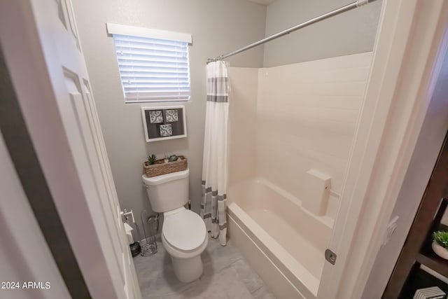 bathroom featuring toilet and shower / tub combo with curtain