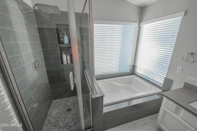 bathroom with shower with separate bathtub, vanity, and a wealth of natural light