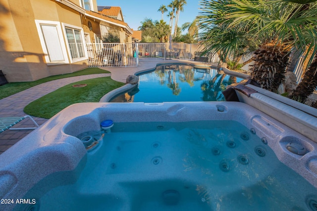 view of swimming pool featuring an outdoor hot tub