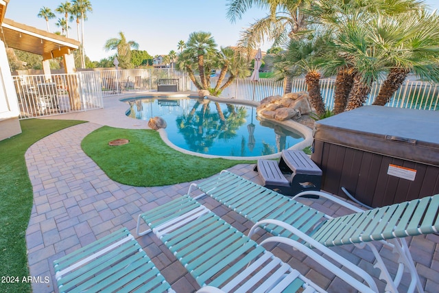 view of pool with a hot tub and a patio