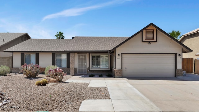 6457 E Encanto St, Mesa, AZ 85205 - ranch-style home with fence, an attached garage, brick siding, driveway, and a shingled roof