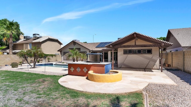 6457 E Encanto St, Mesa, AZ 85205 - rear view of house with a patio area, a fenced backyard, roof mounted solar panels, a pergola, and a fenced in pool