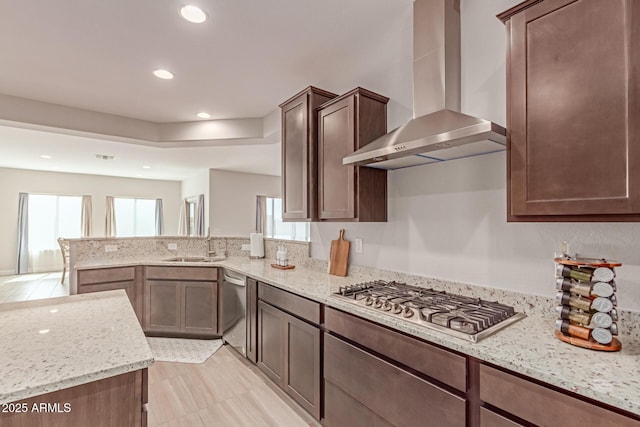 2881 N Riverside Dr, Florence, AZ 85132 - kitchen with wall chimney exhaust hood, appliances with stainless steel finishes, recessed lighting, a peninsula, and light stone counters