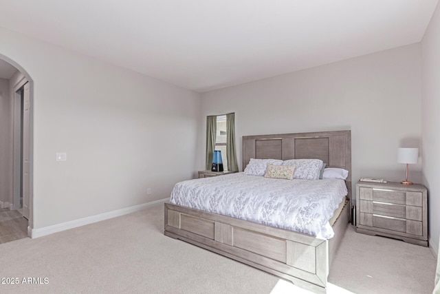 2881 N Riverside Dr, Florence, AZ 85132 - bedroom with arched walkways, light carpet, and baseboards