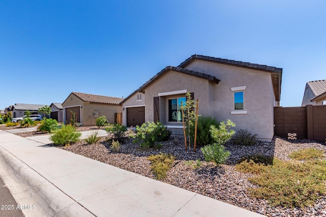 2881 N Riverside Dr, Florence, AZ 85132 - view of front of property featuring an attached garage, stucco siding, fence, concrete driveway, and a tiled roof
