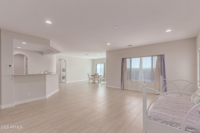 2881 N Riverside Dr, Florence, AZ 85132 - unfurnished room with arched walkways, recessed lighting, light tile patterned floors, and baseboards