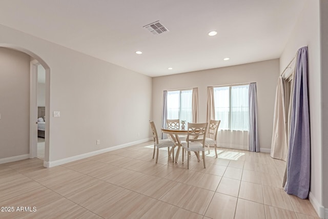 2881 N Riverside Dr, Florence, AZ 85132 - dining room featuring arched walkways, recessed lighting, baseboards, and light tile patterned floors