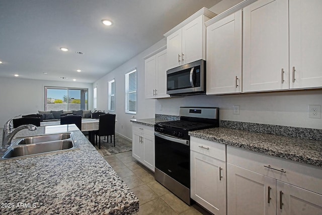 41600 W Dusty Creek Dr, Maricopa, AZ 85138 - kitchen with light tile patterned floors, white cabinetry, a sink, appliances with stainless steel finishes, and recessed lighting