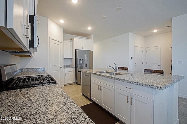 41600 W Dusty Creek Dr, Maricopa, AZ 85138 - kitchen featuring a kitchen island with sink, a sink, stainless steel appliances, light tile patterned floors, and white cabinetry