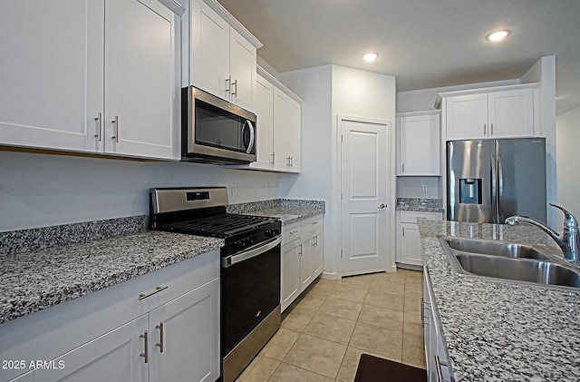 41600 W Dusty Creek Dr, Maricopa, AZ 85138 - kitchen with recessed lighting, a sink, light tile patterned flooring, white cabinetry, and appliances with stainless steel finishes