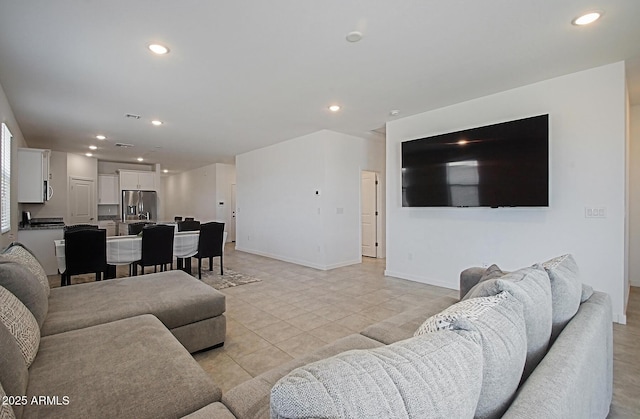 41600 W Dusty Creek Dr, Maricopa, AZ 85138 - living area featuring light tile patterned floors, recessed lighting, and baseboards