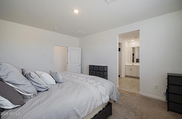 41600 W Dusty Creek Dr, Maricopa, AZ 85138 - bedroom with light colored carpet, connected bathroom, and baseboards