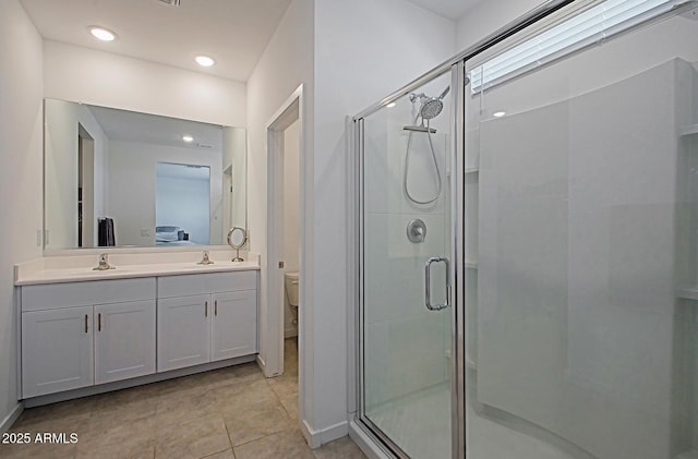 41600 W Dusty Creek Dr, Maricopa, AZ 85138 - full bath with vanity, tile patterned floors, toilet, a stall shower, and baseboards