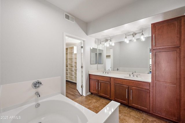 bathroom featuring vanity and a tub