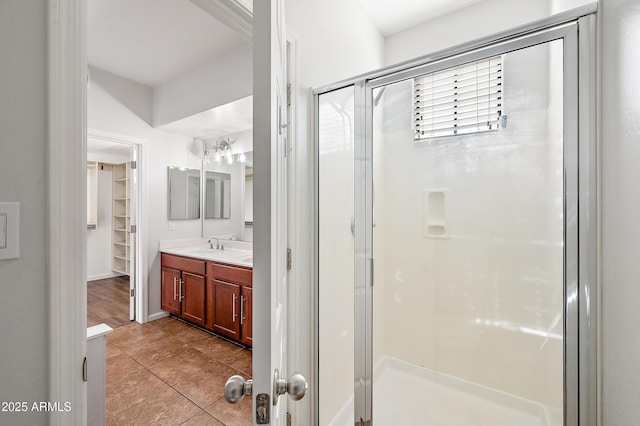 bathroom with vanity, tile patterned floors, and a shower with door