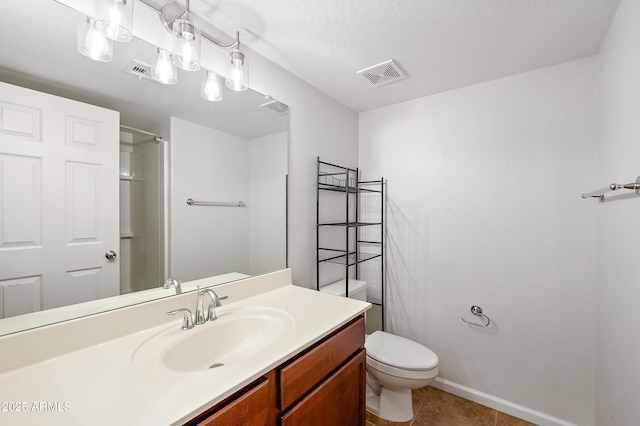 bathroom featuring tile patterned floors, walk in shower, vanity, a textured ceiling, and toilet