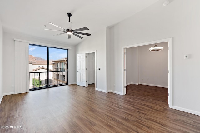 empty room featuring ceiling fan, lofted ceiling, and dark wood-type flooring