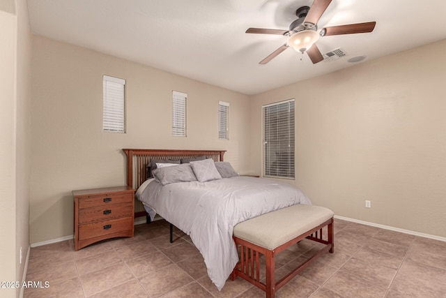 bedroom featuring ceiling fan, light tile patterned floors, visible vents, and baseboards