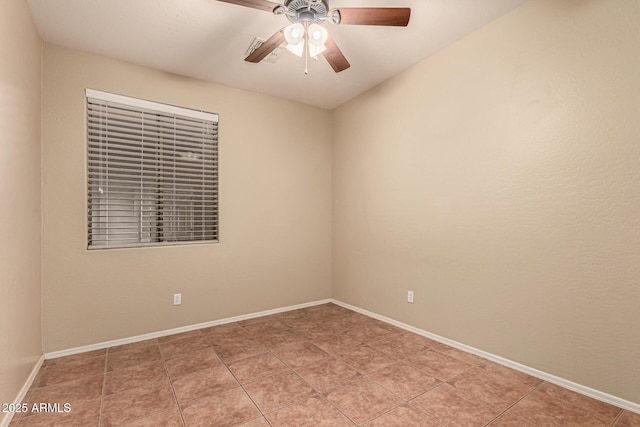 unfurnished room featuring ceiling fan, baseboards, and light tile patterned floors