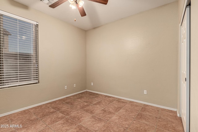 unfurnished bedroom with light tile patterned flooring, ceiling fan, and baseboards