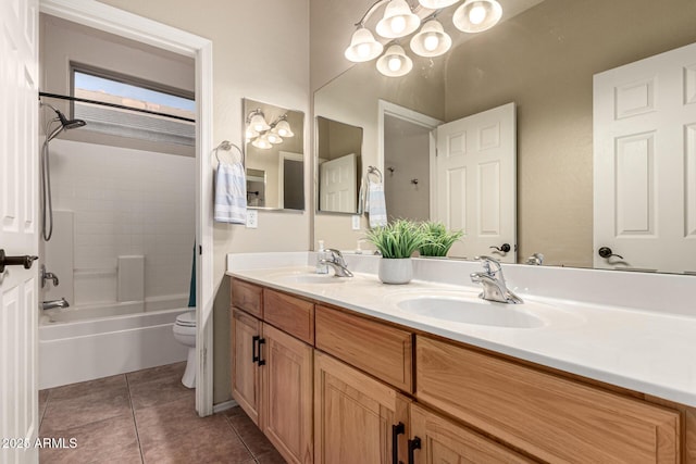 full bathroom featuring double vanity, tile patterned flooring, toilet, and a sink