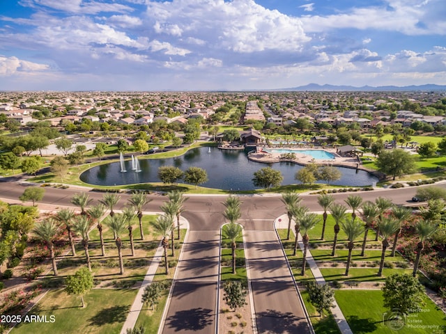 birds eye view of property with a water view