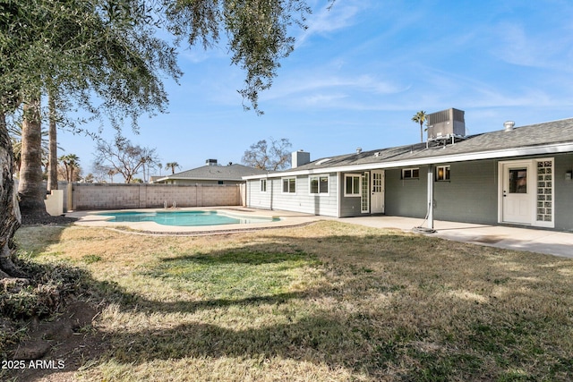 view of yard featuring cooling unit, a patio area, and a fenced in pool