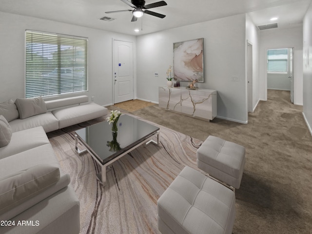 living room with ceiling fan and carpet