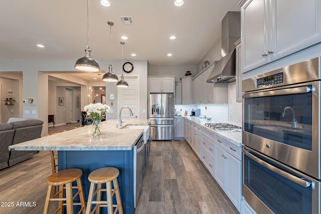 10207 W Hedge Hog Pl, Peoria, AZ 85383 - kitchen featuring appliances with stainless steel finishes, a sink, a kitchen breakfast bar, recessed lighting, and dark wood finished floors