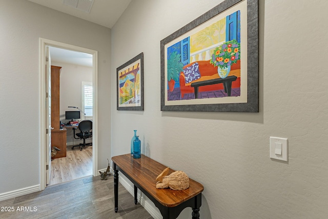 10207 W Hedge Hog Pl, Peoria, AZ 85383 - corridor featuring wood finished floors, a desk, and baseboards