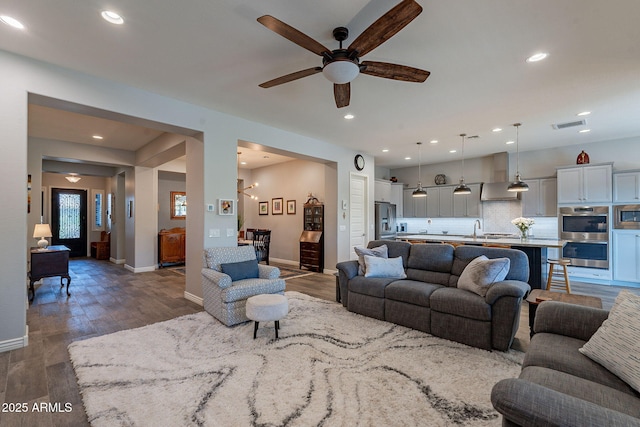 10207 W Hedge Hog Pl, Peoria, AZ 85383 - living room featuring ceiling fan, wood finished floors, baseboards, and recessed lighting