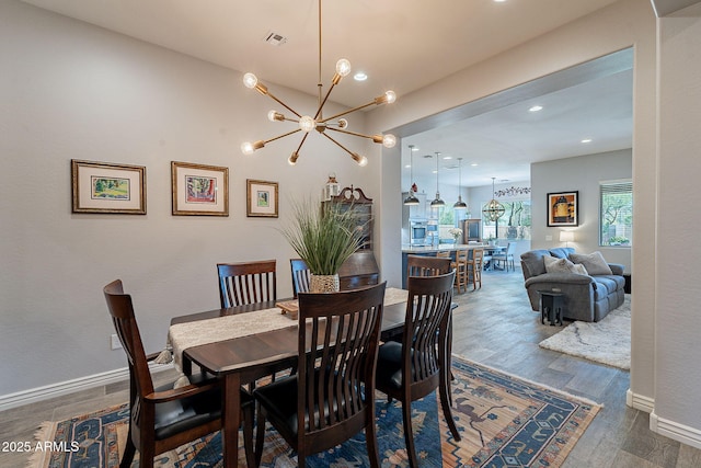 10207 W Hedge Hog Pl, Peoria, AZ 85383 - dining room featuring a chandelier, wood finished floors, recessed lighting, and baseboards