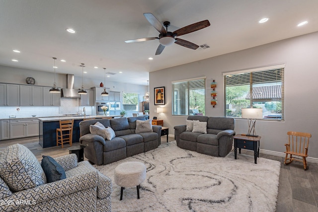 10207 W Hedge Hog Pl, Peoria, AZ 85383 - living room featuring wood finished floors, a ceiling fan, baseboards, and recessed lighting