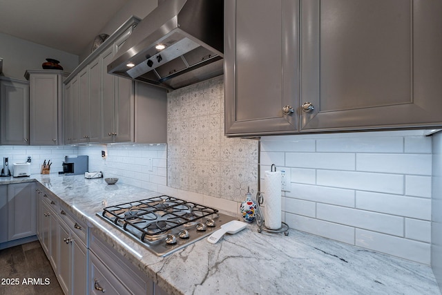10207 W Hedge Hog Pl, Peoria, AZ 85383 - kitchen with wall chimney range hood, stainless steel gas cooktop, gray cabinets, decorative backsplash, and lofted ceiling