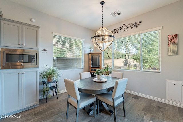 10207 W Hedge Hog Pl, Peoria, AZ 85383 - dining space featuring a chandelier, plenty of natural light, dark wood-style floors, and baseboards