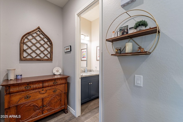 10207 W Hedge Hog Pl, Peoria, AZ 85383 - corridor with light wood-type flooring, a sink, and baseboards