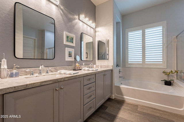 10207 W Hedge Hog Pl, Peoria, AZ 85383 - full bathroom with wood finished floors, double vanity, and a bath