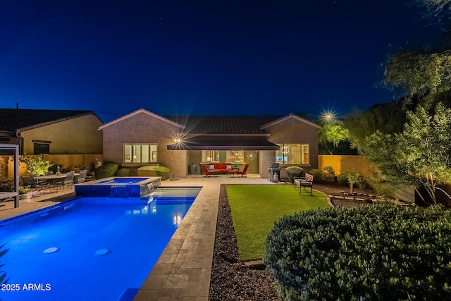 10207 W Hedge Hog Pl, Peoria, AZ 85383 - pool at night featuring a patio, a fenced backyard, area for grilling, and a pool with connected hot tub