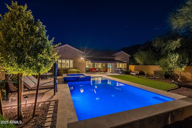 10207 W Hedge Hog Pl, Peoria, AZ 85383 - pool at twilight with a patio area, a fenced backyard, and a pool with connected hot tub