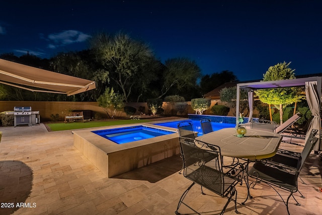 10207 W Hedge Hog Pl, Peoria, AZ 85383 - pool at night with an in-ground hot tub, a patio, grilling area, and a fenced backyard