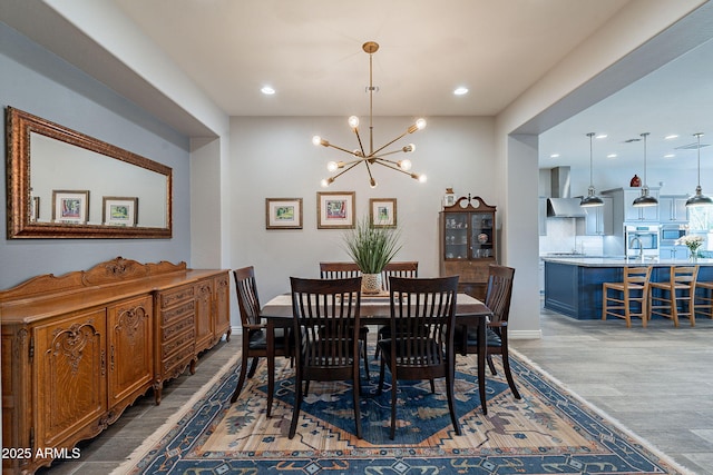 10207 W Hedge Hog Pl, Peoria, AZ 85383 - dining space featuring a chandelier, recessed lighting, wood finished floors, and baseboards