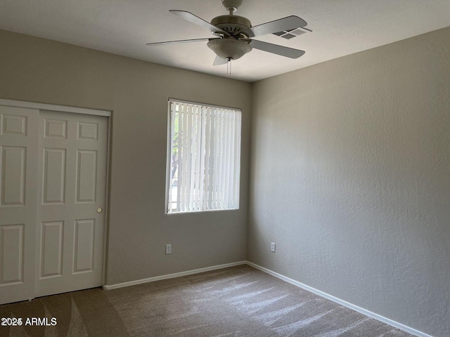 unfurnished bedroom with visible vents, ceiling fan, baseboards, and carpet floors