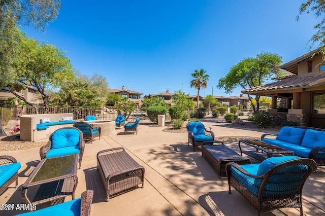 view of patio with an outdoor living space and fence